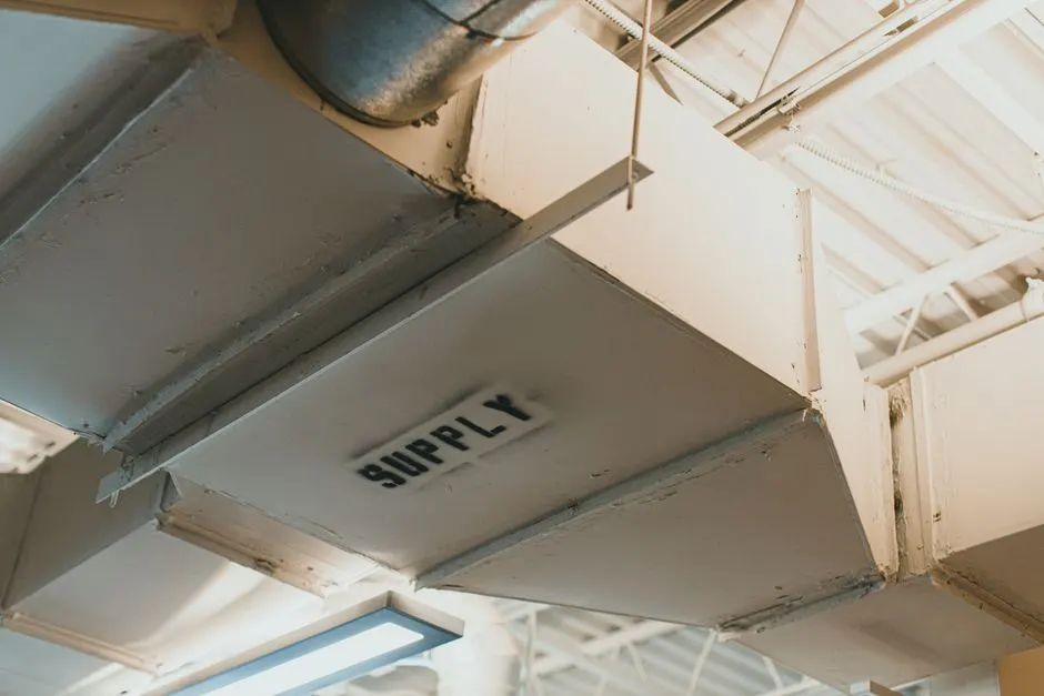 Close-up view of an air duct labeled 'SUPPLY' in an industrial setting.